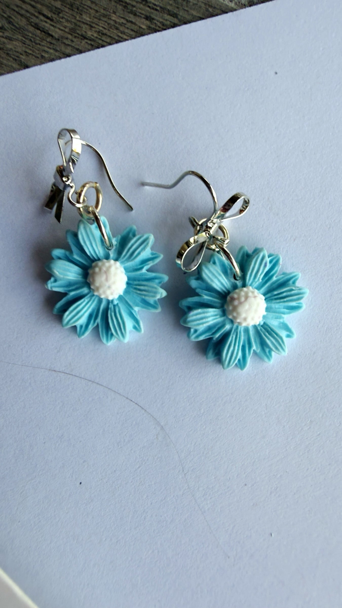 Blue Bottle Crafts handcrafted blue polymer clay flower earrings with white centers and silver metal hooks